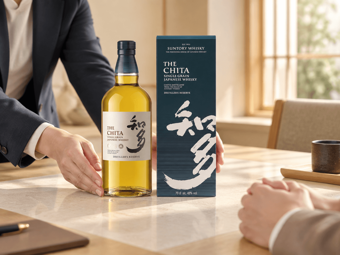 Presenting The Chita whisky and its box to a buyer across a meeting table